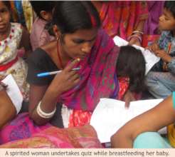 A woman takes quiz while breastfeeding her child