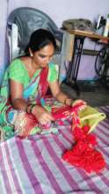 Woman weaving garment in slum house