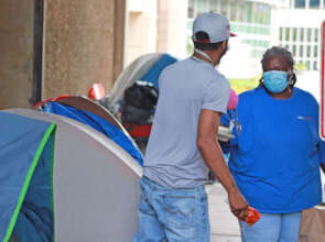 Lisa West of UPO's Shelter Hotline gives out food