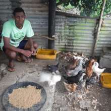 Rahul with his happy chickens on a rainy day.