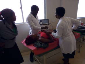 Liz & JB evaluating a patient at Masaka