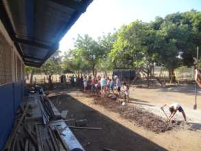 Students helping dig the trench at our school