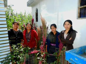 Mujeres Oxlajuj E in the bakery's  amaranth patch