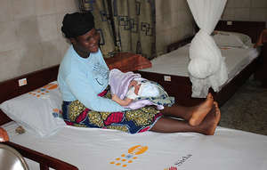 A woman and her baby rest at a UNFPA clinic
