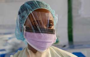 A healthcare worker in protective equipment