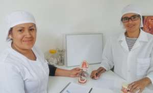 Paola wearing glasses with Laura --both mothers