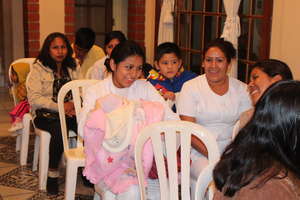 Young indigenous mother with baby & other students