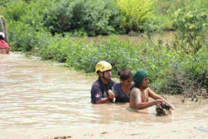 Rescue workers help families get to safe ground