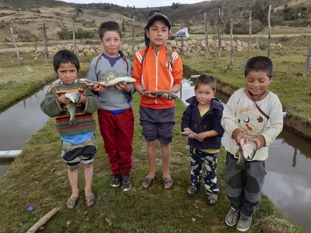 Local children with harvested trout