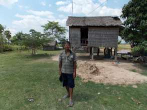 Moringa project farmer in front of his home