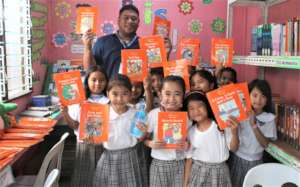 Teacher with students in library