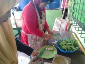 Parents prepare lunch daily with garden veggies