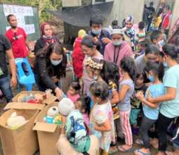 Children receive a toy at homecoming event