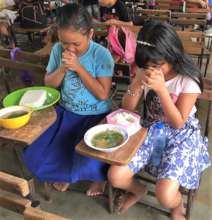 Christian children praying before lunch