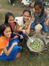 Children learning to cook own meals at school