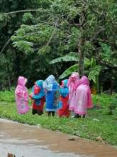 Raincoats keep students dry as they walk to school