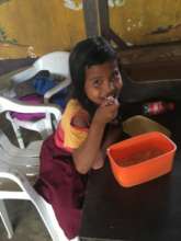 Refugee child happy to be provided with food