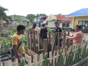 The well is being built next to the school garden