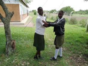 ORPHAN GIRL CHILDREN POSE FOR A PHOTO AT SCHOOL