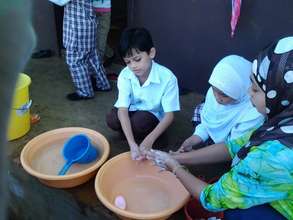 teachers wash with students at Sahaya before lunch
