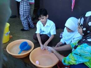 teachers wash with students at Sahaya before lunch