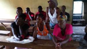 Beneficiaries listening to GGUK Volunteers