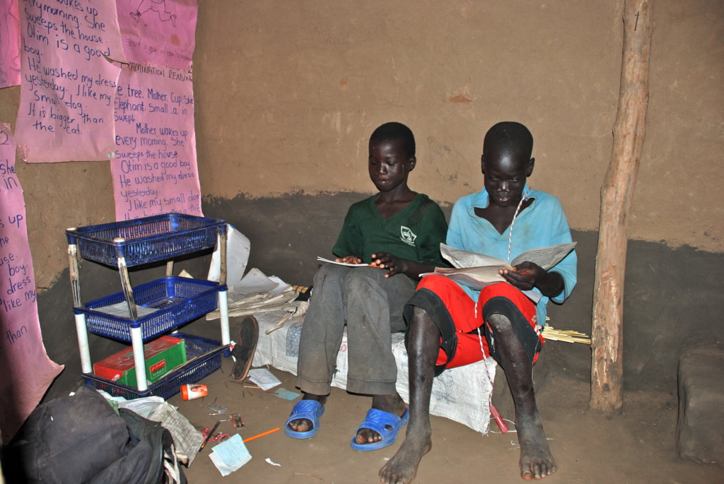 Julius in his reading hut wishing to be in school