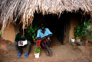 Julius reading next to Sebastian outside their reading hut.JPG