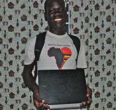 Sebastian proudly holding his laptop