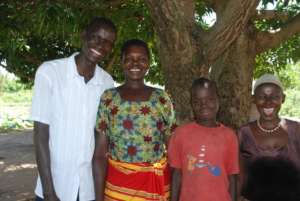 Stephen with three family members in their village