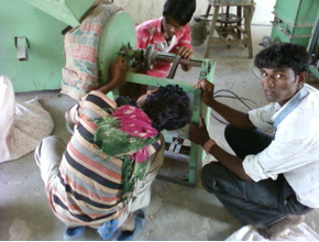 members fixing a part in the Mill