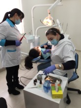SOAR dental clinic nurse cleaning teeth of a child