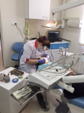 Dental Hygienist cleaning a child's teeth