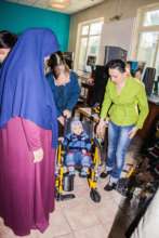 A disabled child getting a wheelchair in the cafe