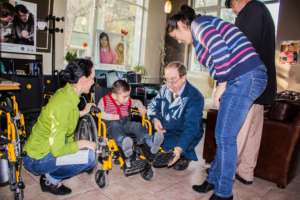 Giving away wheelchairs to kids with disabilities