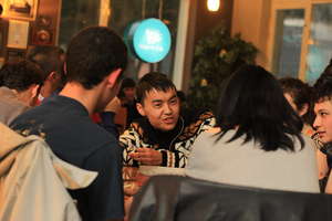A volunteers chatting with friends in the cafe