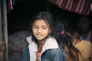 A girl takes shelter from the rain