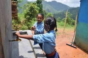 Anjuta and Aashika wash their hands