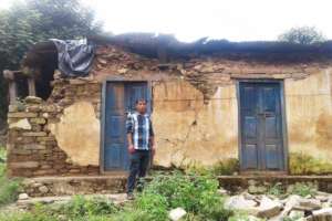 Shambu stands in front of his home today