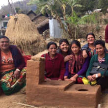 Trainers and trainees with new adobe stove
