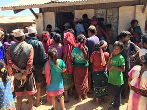 Lining up to get food supplies delivered by ADWAN