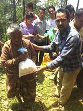 Distributing rice and dal to villagers