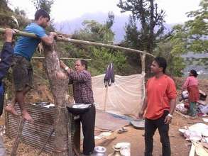 Older boys help to build shelters