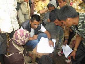 Forms being filled before relief distribution