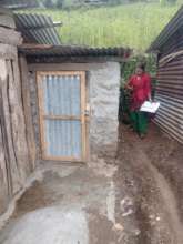 A PHASE supervisor observing a newly built toilet