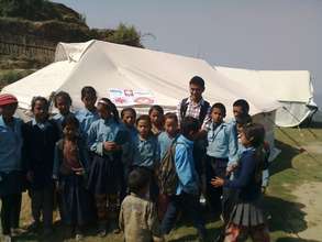 Children outside a school tent