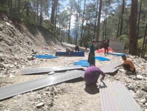 Flood-affected family receiving CGI sheets