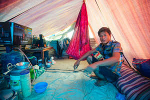 Som, a carpet weaver, at the factory site.