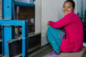 A weaver at a rebuilt GoodWeave carpet factory.
