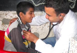 A young patient is treated at an HHC medical camp